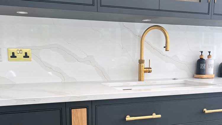 Elegant stone kitchen with carefully planned worktops, splashback and island details